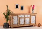 Side angle image of a Talaja handcrafted solid mango wood sideboard with intricately hand-carved doors, natural wood grain, traditional Indian patterns, and spacious storage, 180cm.