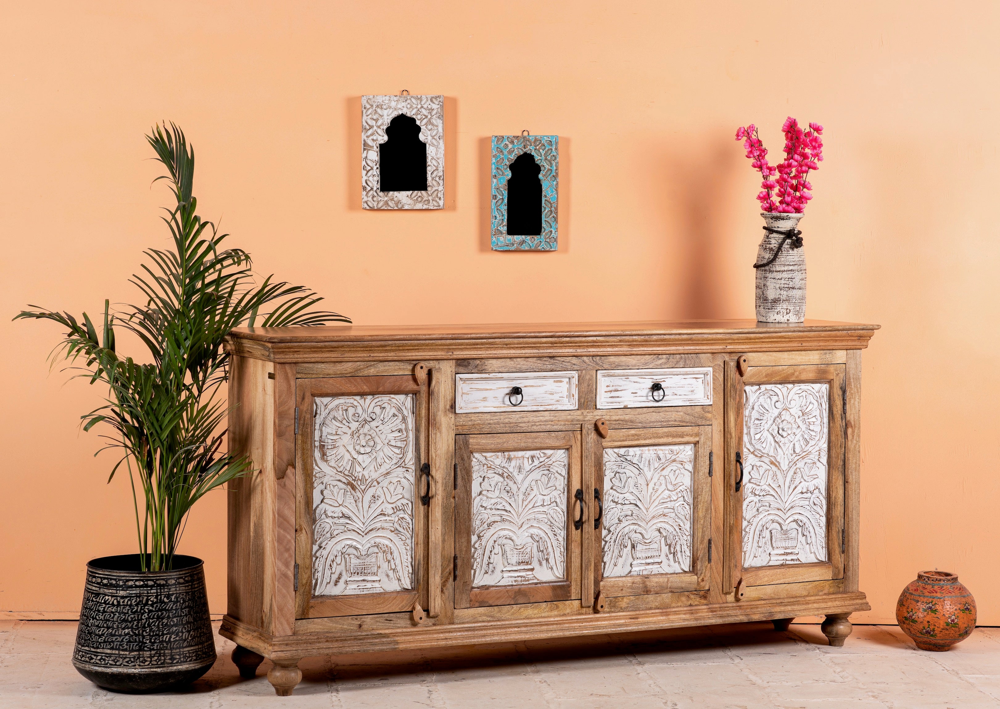 Side angle image of a Talaja handcrafted solid mango wood sideboard with intricately hand-carved doors, natural wood grain, traditional Indian patterns, and spacious storage, 180cm.