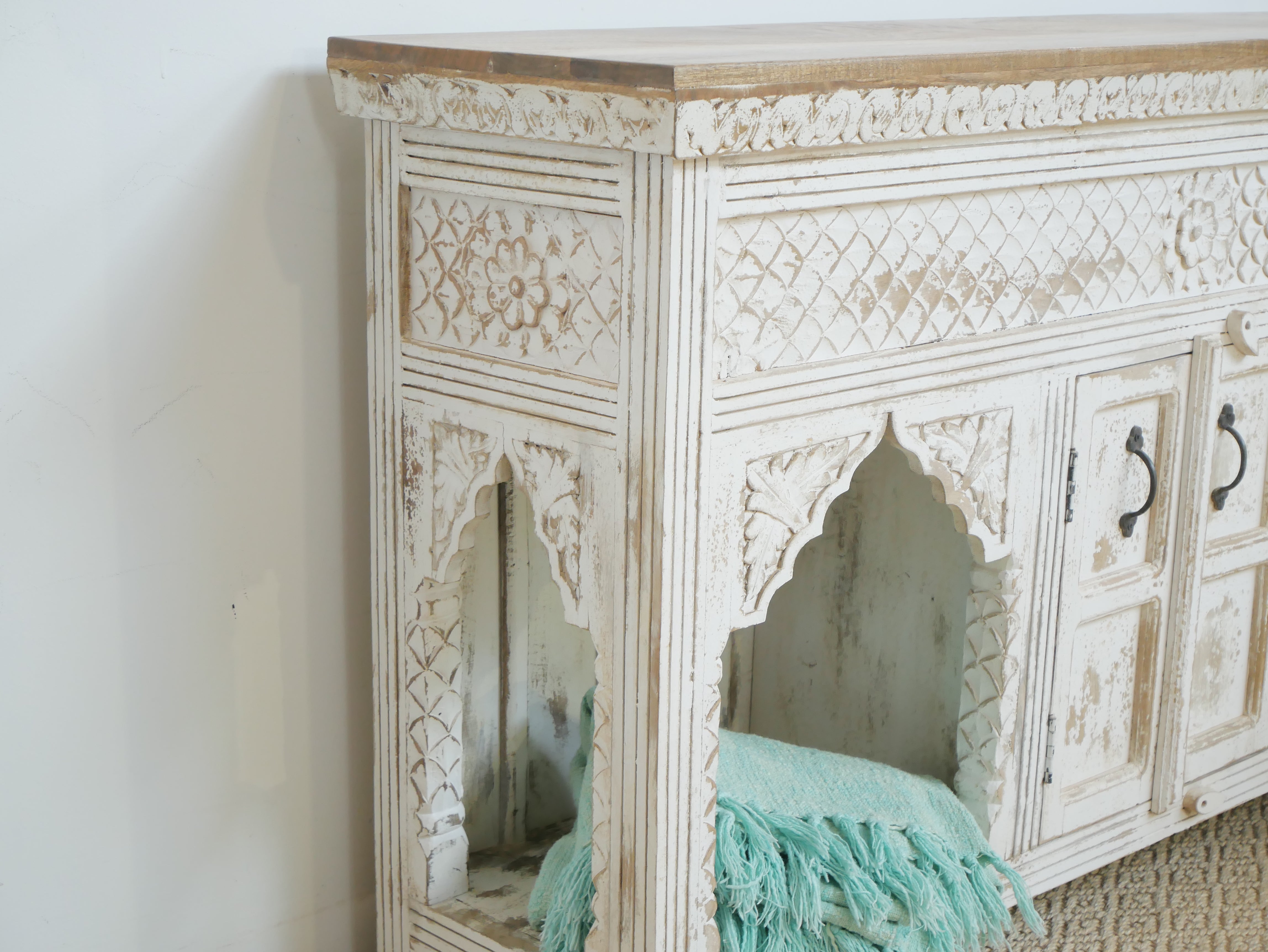 Side angle image of a Teerth hand carved white washed mango wood console table with natural wood top 150cm