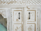 Close up image of a Teerth hand carved white washed mango wood console table with natural wood top 150cm